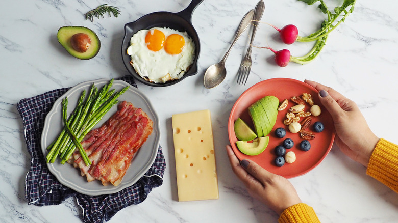 Woman preparing breakfast with bacon