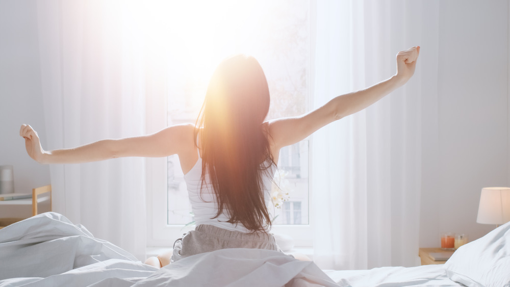 Woman happily waking up