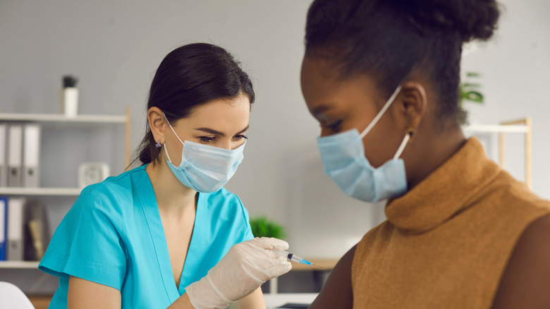 Woman getting COVID-19 vaccine