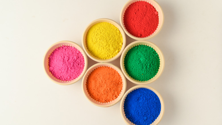 various powdered food colorings in ramekins 