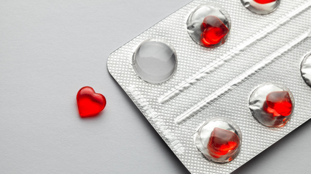 Heart-shaped pill next to blister pack