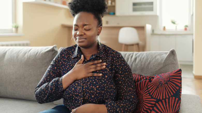 Woman holding chest