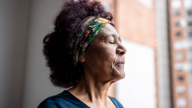 Woman inhaling with closed eyes