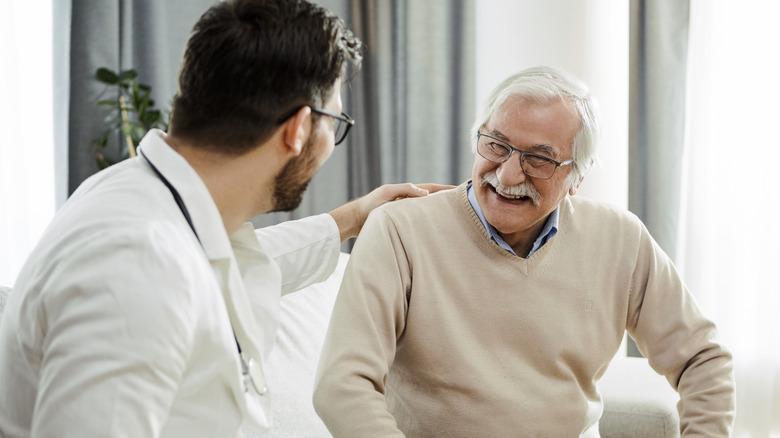 older man talking with his doctor