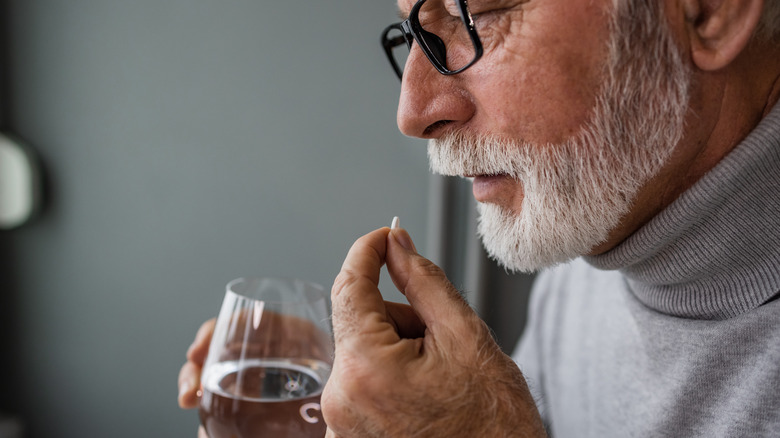 senior man taking medication