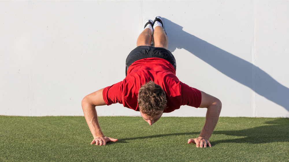 Man doing decline pushups outdoors