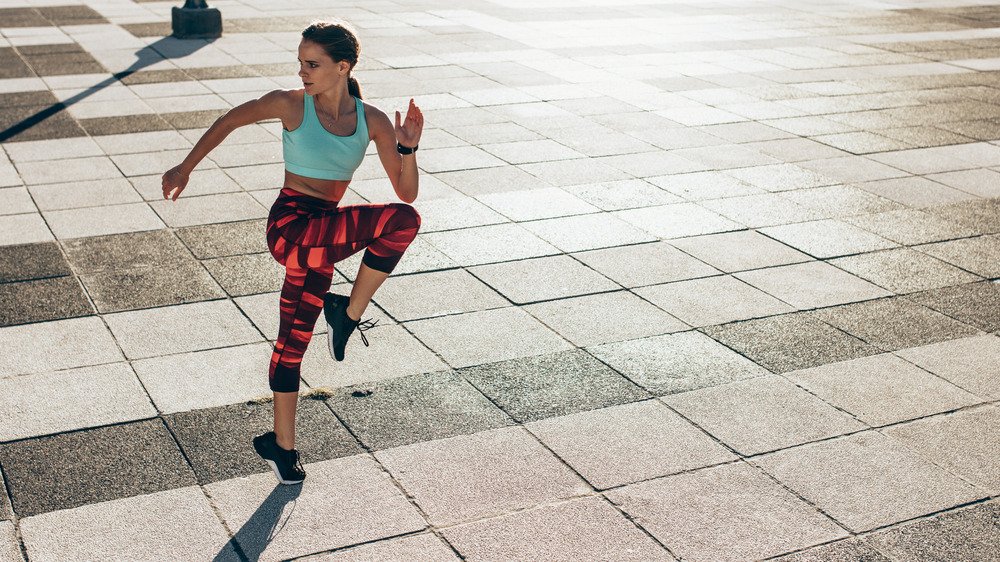 Woman performing a jumping lunge