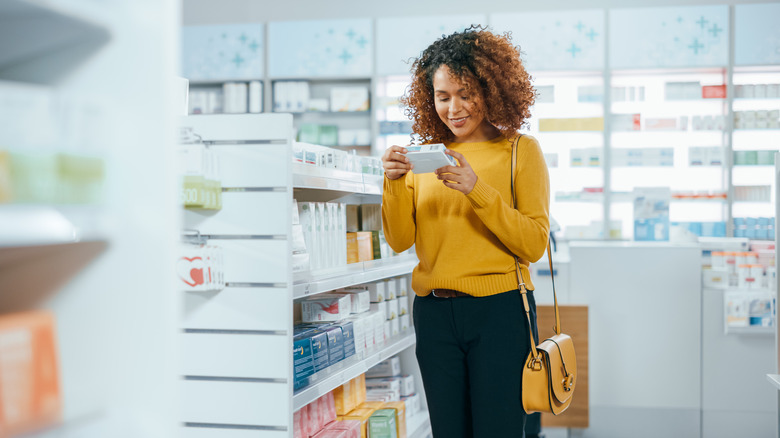 woman inspecting her supplements at the store