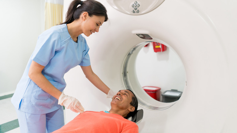 Smiling man undergoing MRI