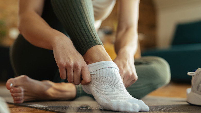 Woman getting dressed in yoga clothes