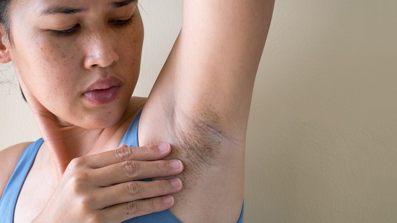 woman looking at underarm