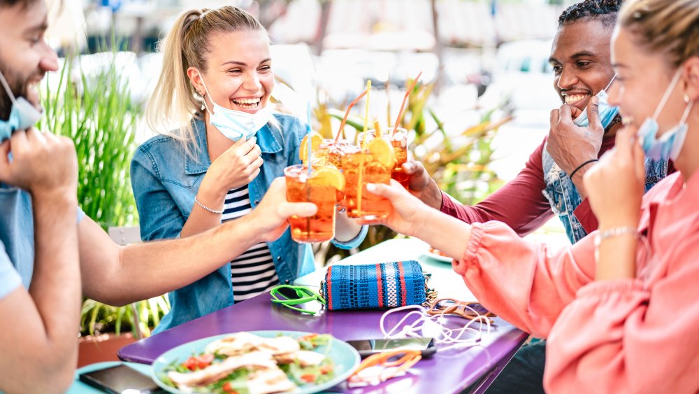 toast with masks on at restaurant  during COVID-19