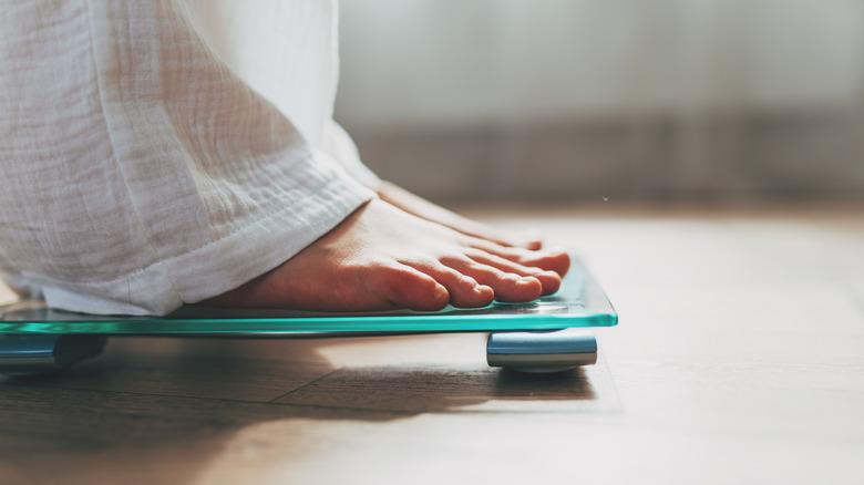 Woman on weighing scale