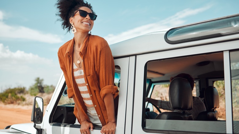 Woman hanging outside a vehicle window