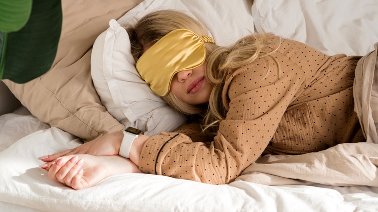 woman sleeping with gold eye mask