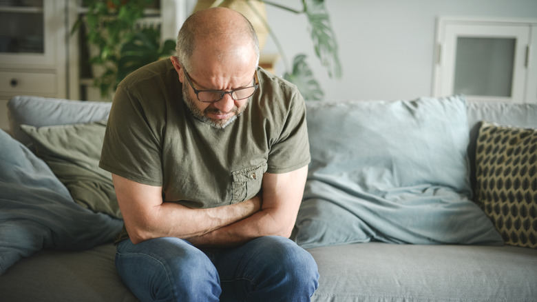 Man holding stomach