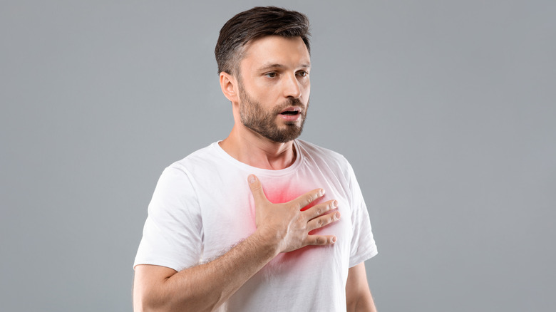 Man with asthma holding chest