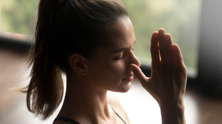 woman practicing alternate nostril breathing