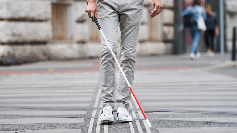 blind man walking with cane