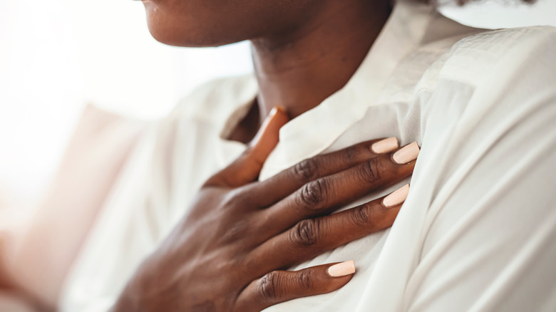 young woman feeling pain in chest