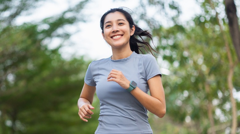 smiling woman running outdoors