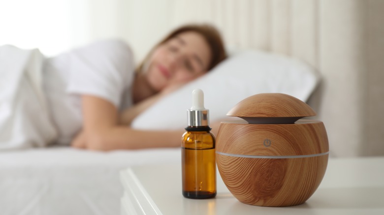 woman sleeping near a scent diffuser