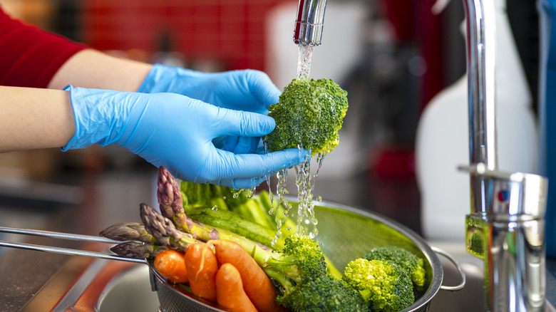 rinsing vegetables in a kitchen sink