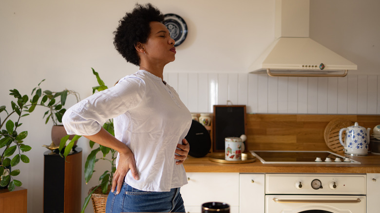 Woman experiencing digestion issues holding stomach