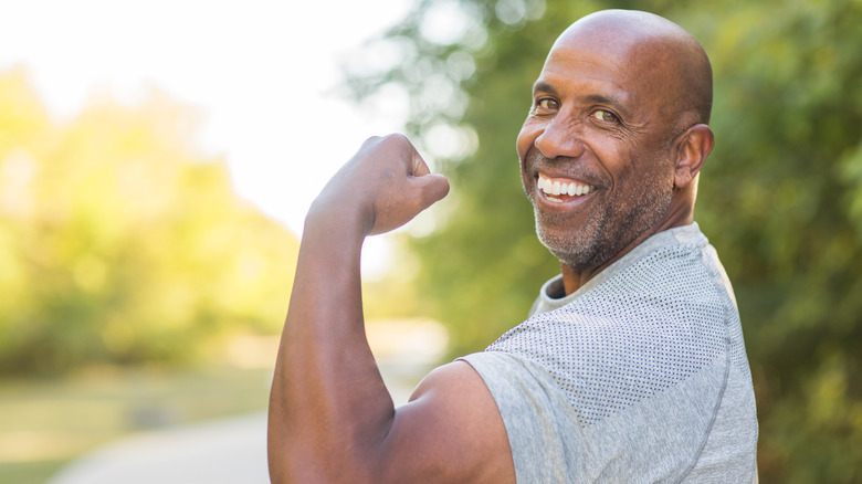 Man flexing and making a muscle