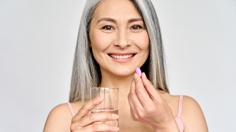 Woman taking calcium supplements