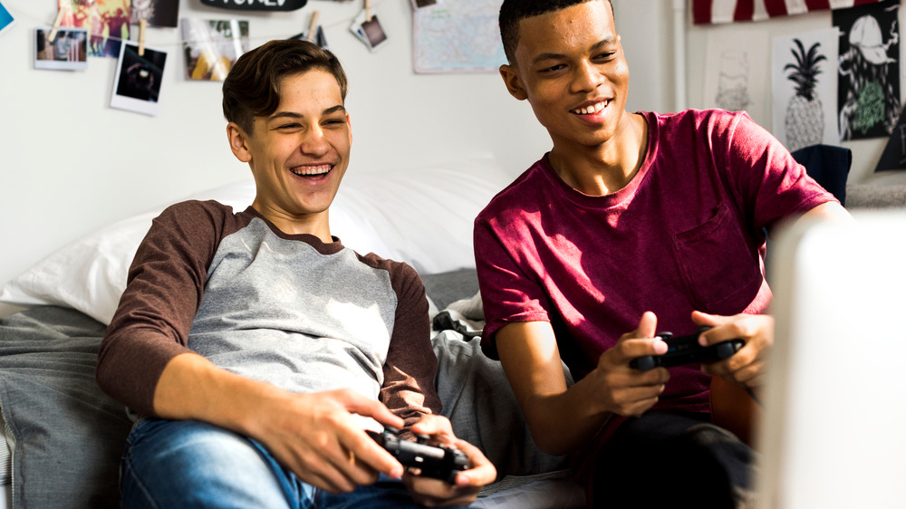 Teen boys happy playing video games