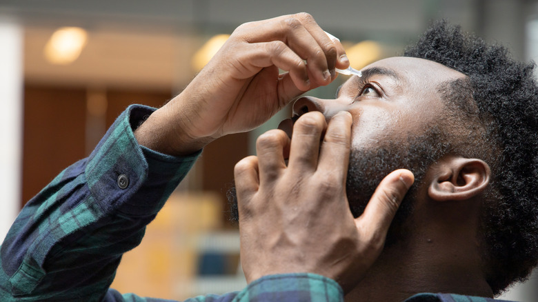 A man using eye drops