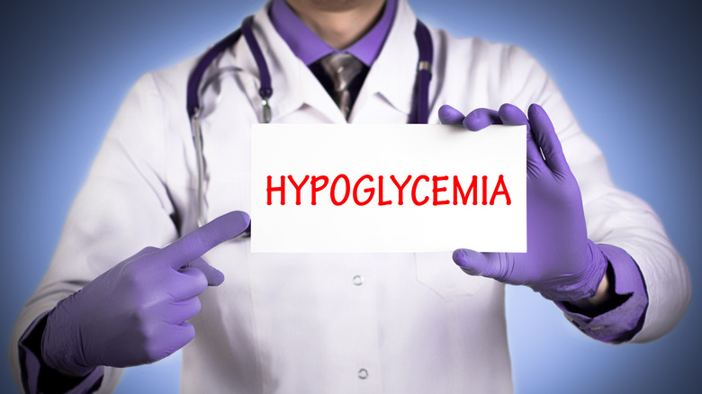 Doctor holding up a sign that says "hypoglycemia"