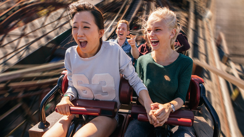 Young people enjoying a roller coaster
