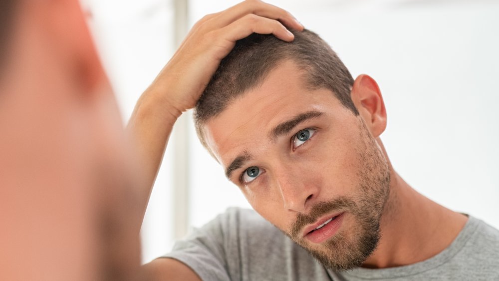 young man looking in mirror