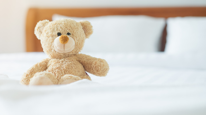 Stuffed teddy bear on bed