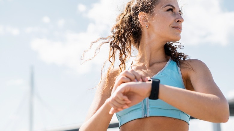 woman wearing fitness tracker on wrist 