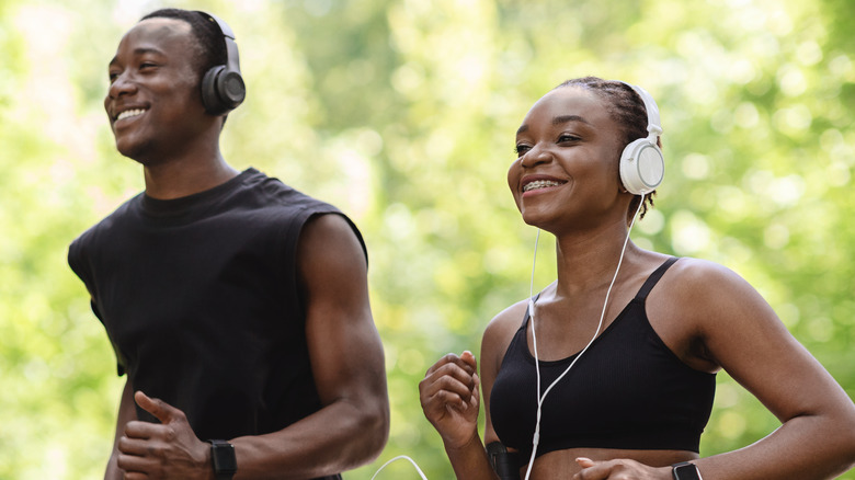 Couple smiling while jogging together 