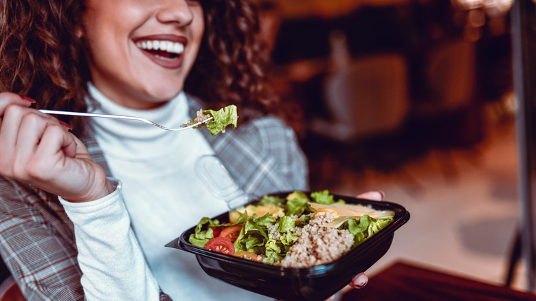 Woman eating salad with tuna