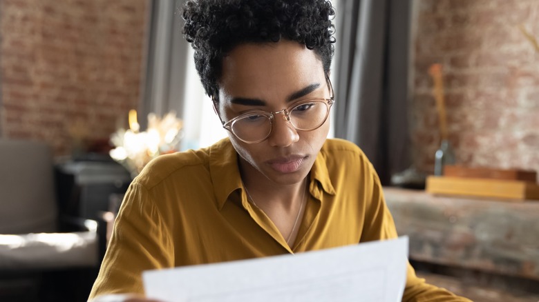 Focused woman examining document