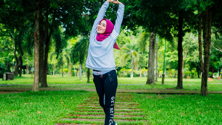 Woman stretching while walking