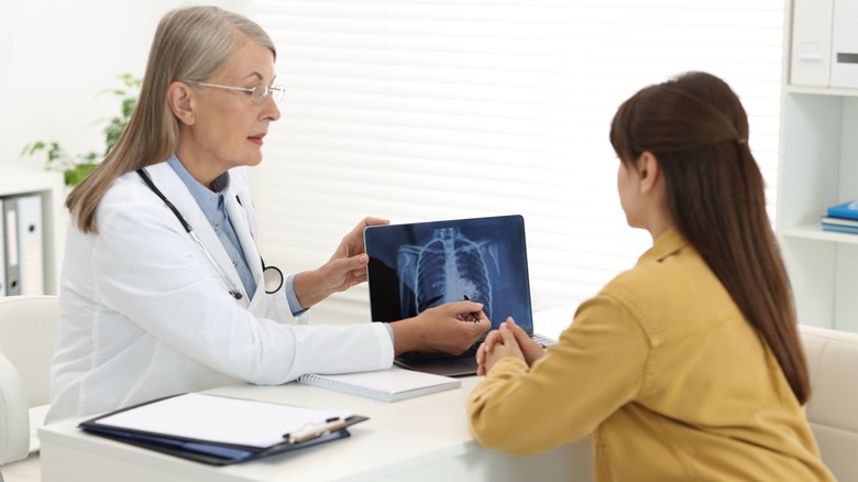 doctor showing patient chest x-ray results