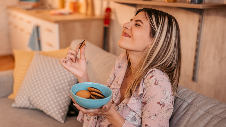 Woman smiling while eating cookies