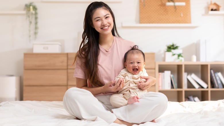 woman holding her happy baby