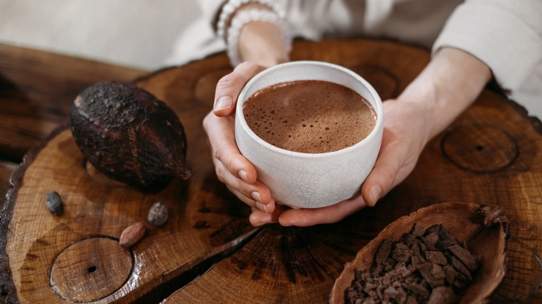 woman holding mug of hot cocoa 
