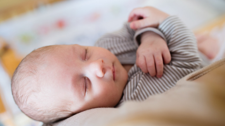 Baby sleeping with crossed arms