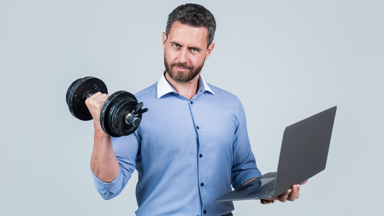 creepy guy with dumbbell and laptop