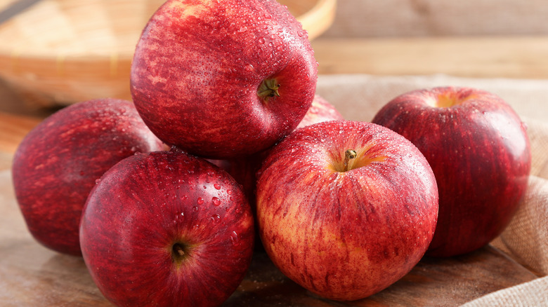 Red apples on wooden surface