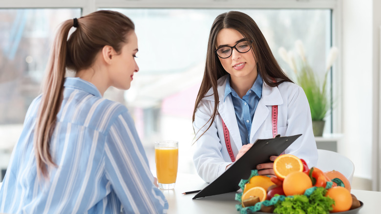 Nutrition coach talking to a client in an office