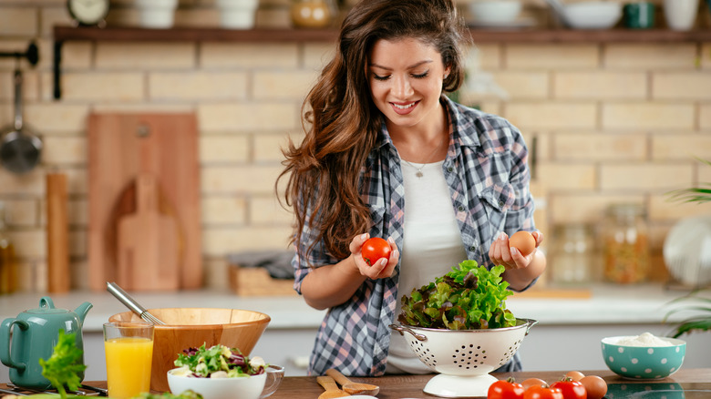 Woman cooking healthy food in a modern kitchen